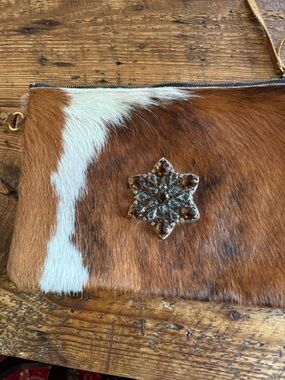 Cow hide wristlet Clutch with Jeweled Star Accent. Never used.